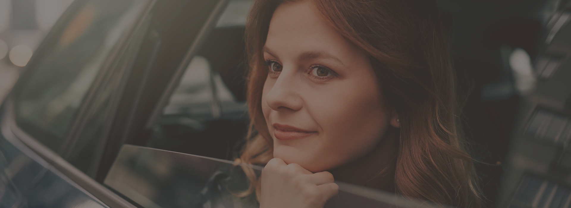 woman looking out car window