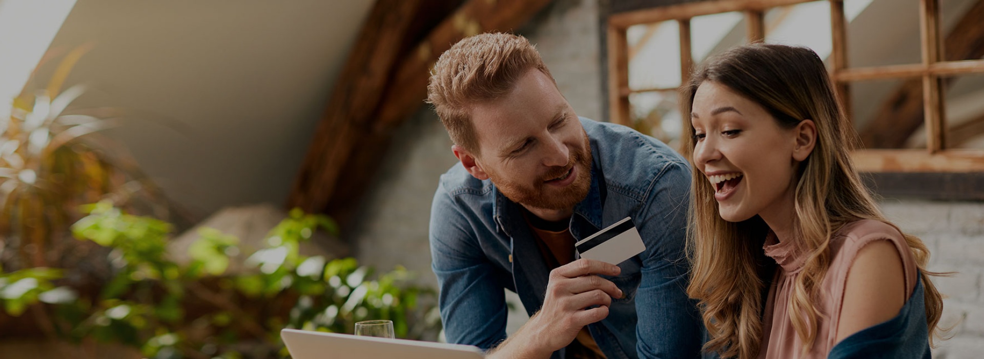 Image of couple holding credit card